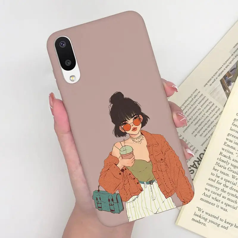 a woman holding a book and a phone case