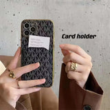 a woman holding a cell phone with a card holder