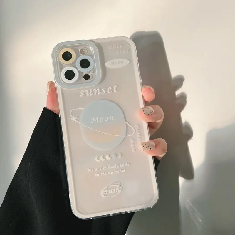 a woman holding a phone case with a heart on it