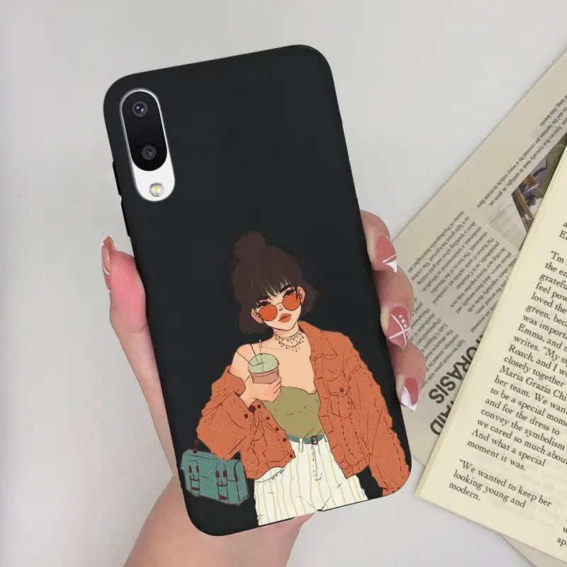 a woman holding a book and a phone case