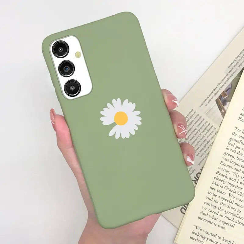 a woman holding a book and a phone case