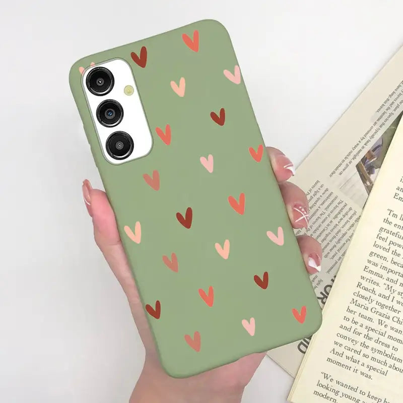 a woman holding a book and a phone case