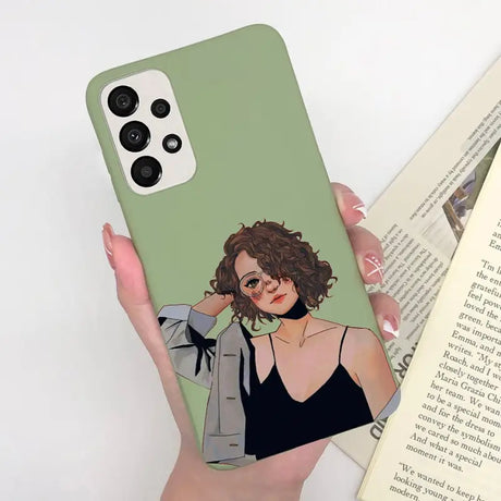 a woman holding a book and a green phone case