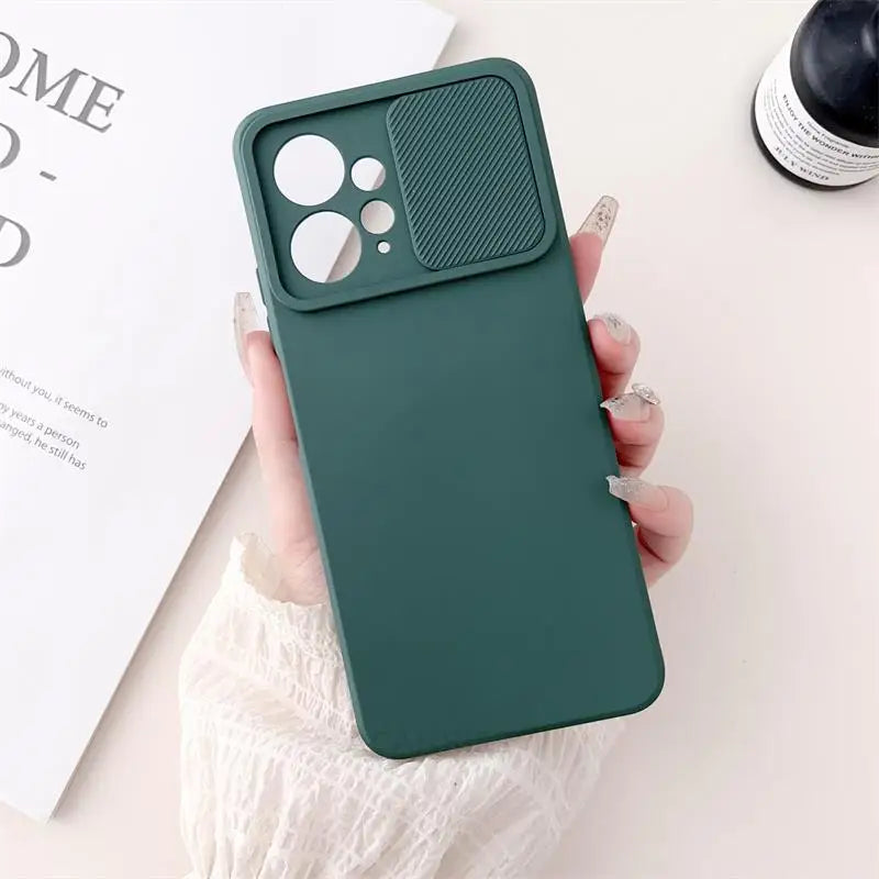 a woman holding a green phone case