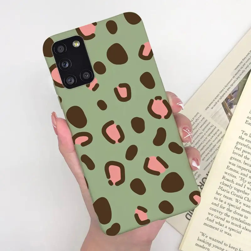 a woman holding a book and a phone case