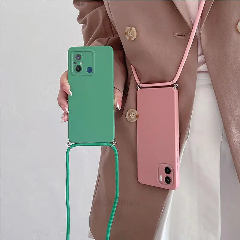 a woman holding a green and pink phone case