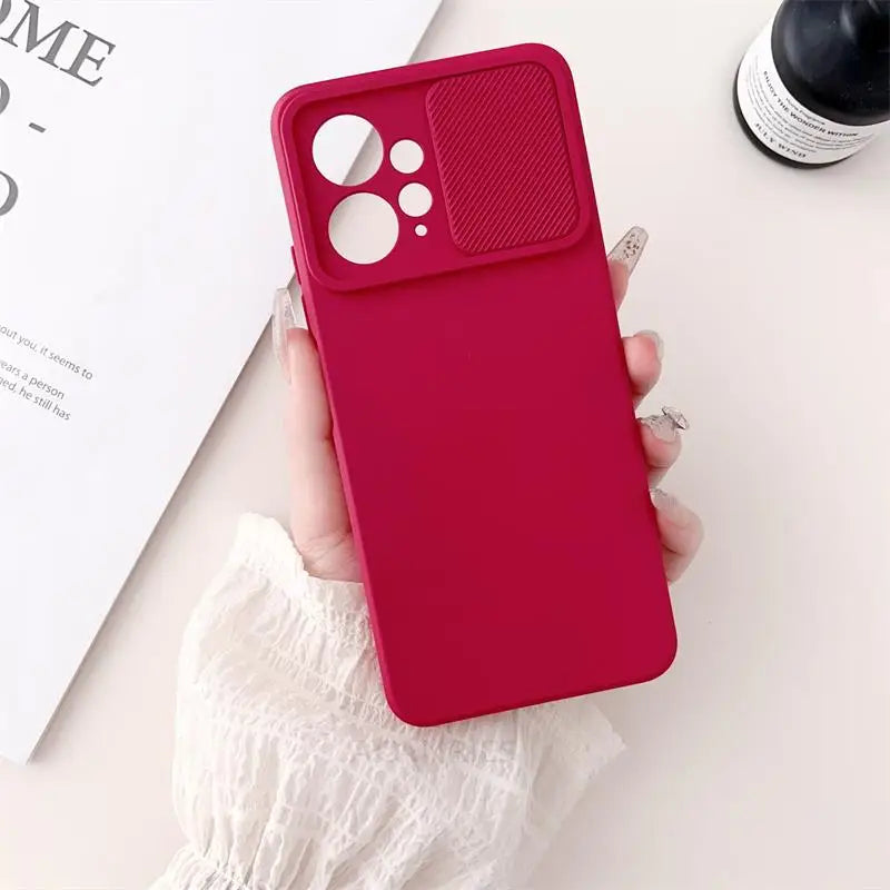 a woman holding a red iphone case