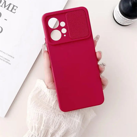 a woman holding a red iphone case