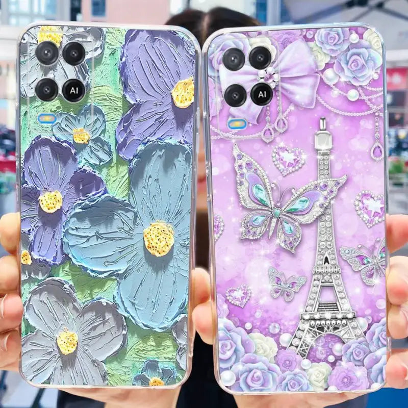 a woman holding two iphone cases with a purple and blue design