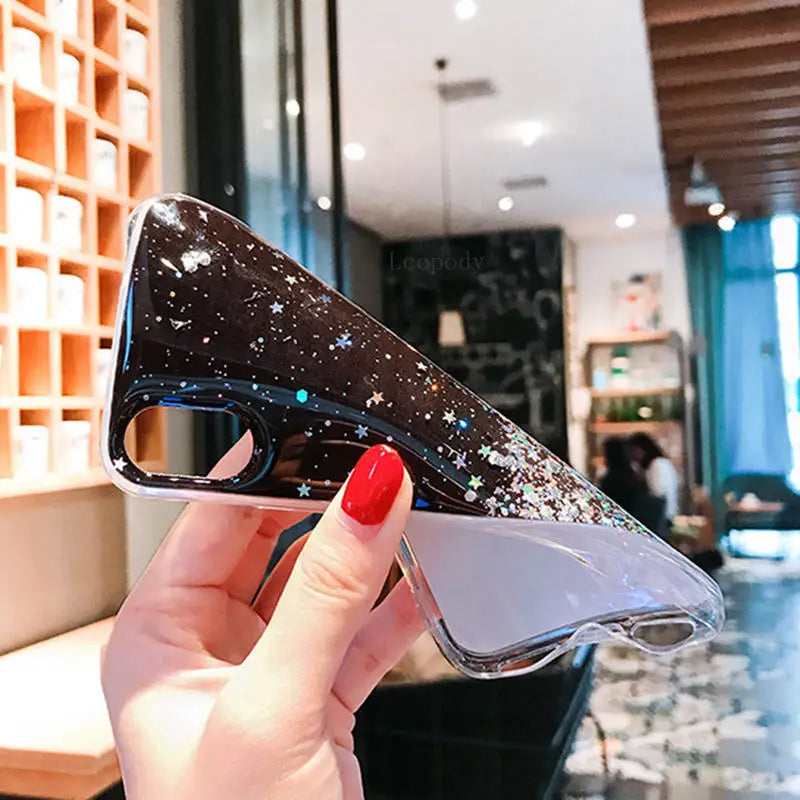 a woman holding up a pair of glasses