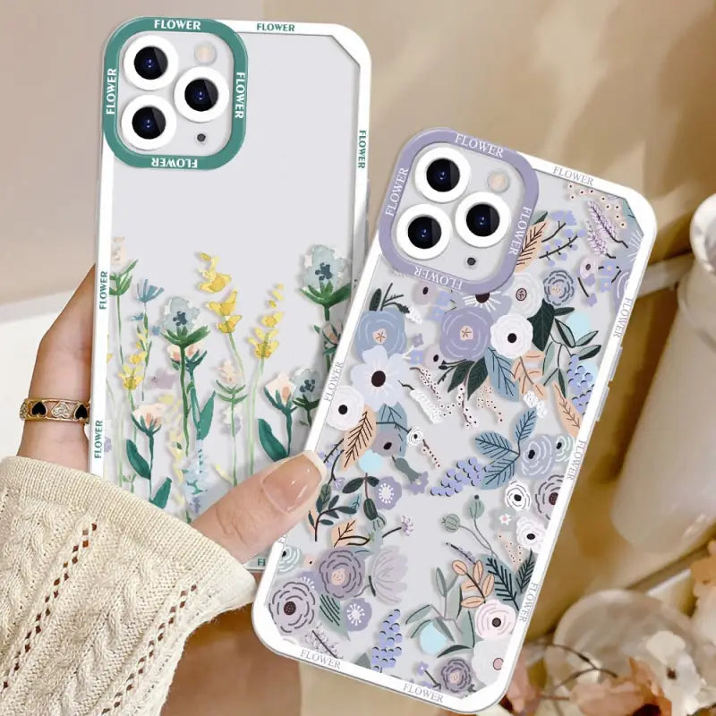 a woman holding a phone case with flowers on it