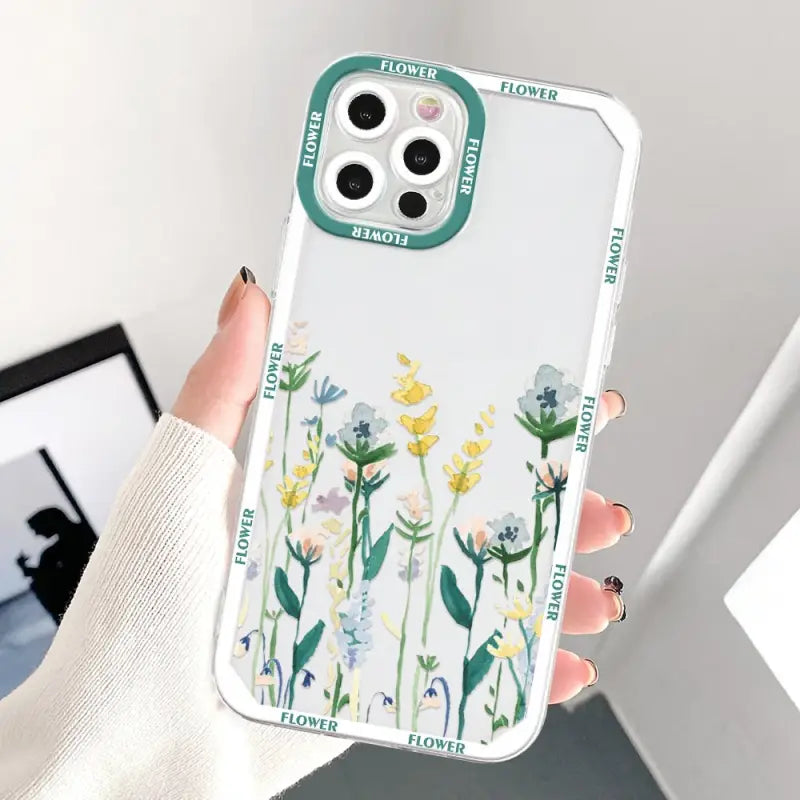 a woman holding a phone case with flowers on it