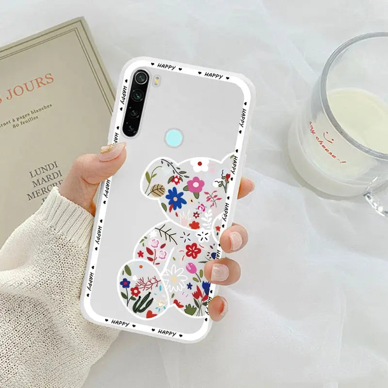 a woman holding a phone case with a flower design