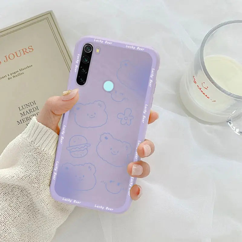 a woman holding a phone case with a purple background