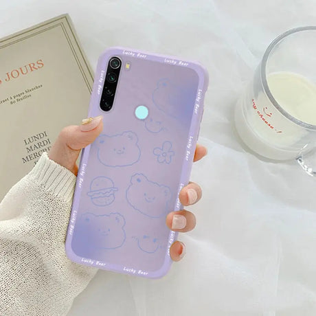 a woman holding a phone case with a purple background