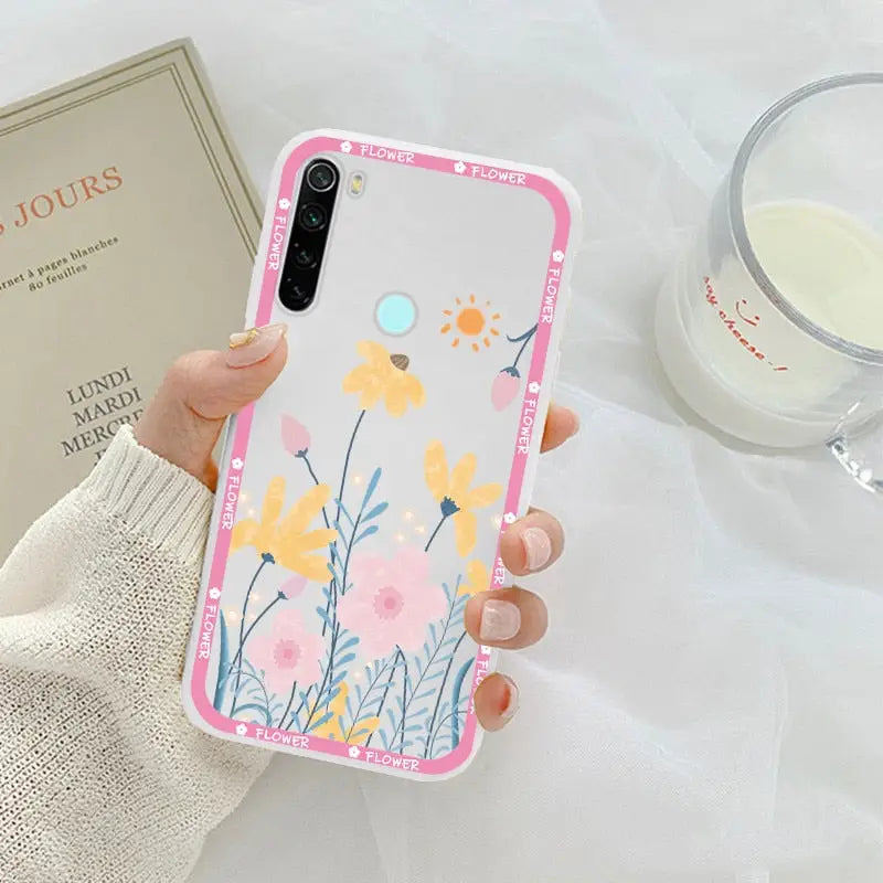 a woman holding a phone case with flowers on it