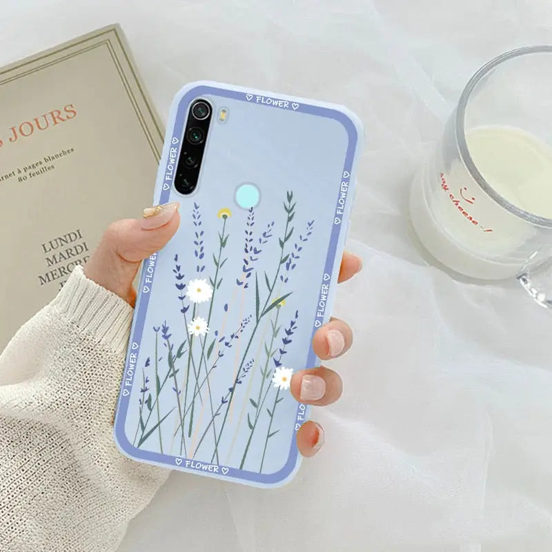 a woman holding a phone case with a flower design