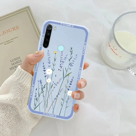 a woman holding a phone case with a flower design