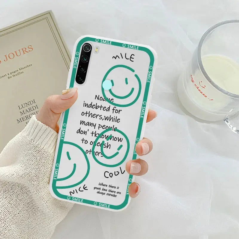 a woman holding a phone case with a quote on it