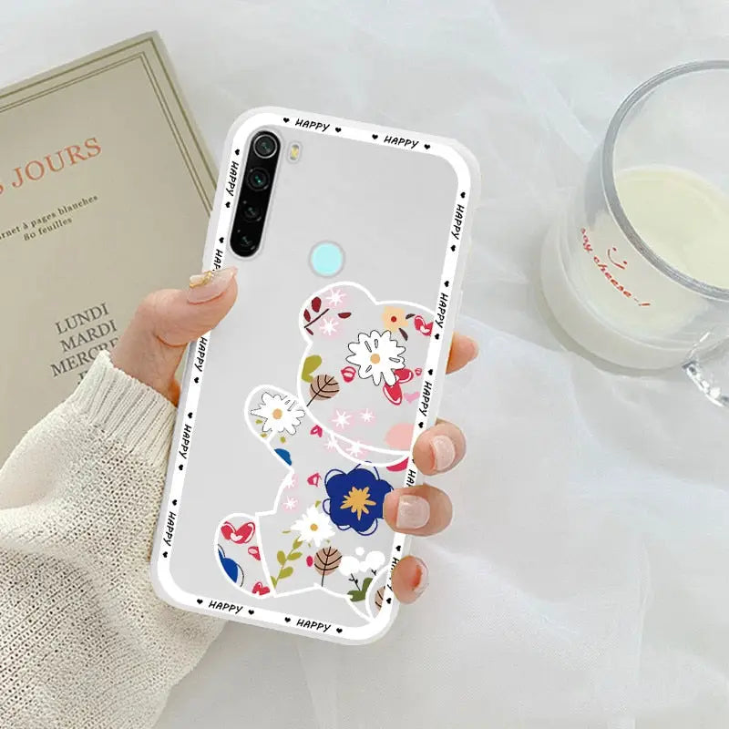 a woman holding a phone case with flowers on it