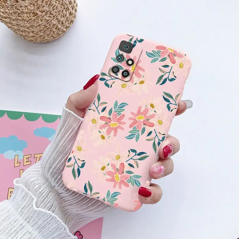 a woman holding a phone case with flowers on it