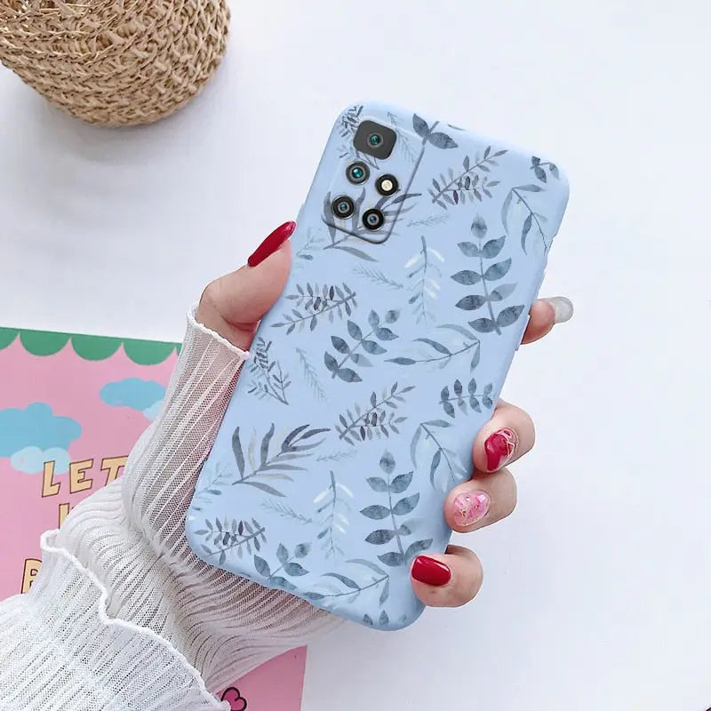 a woman holding a phone case with a floral pattern