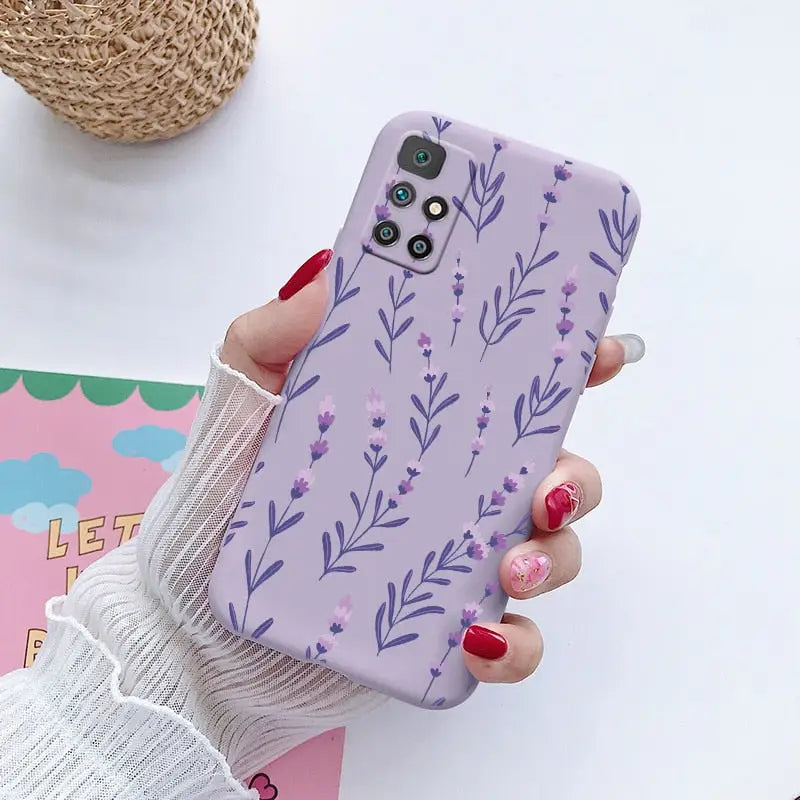 a woman holding a phone case with purple flowers on it