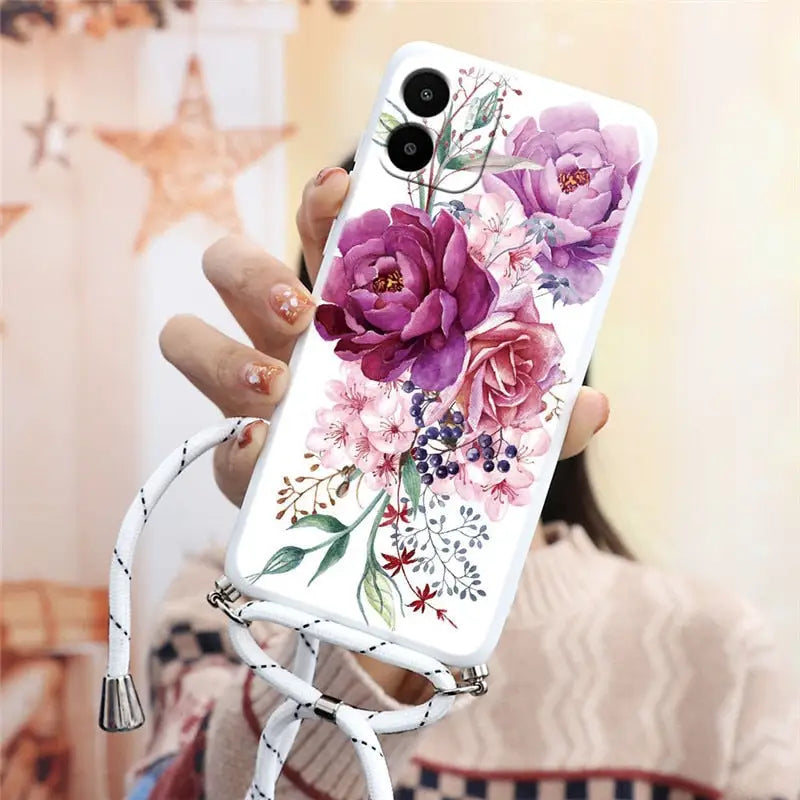 a woman holding a phone case with flowers on it