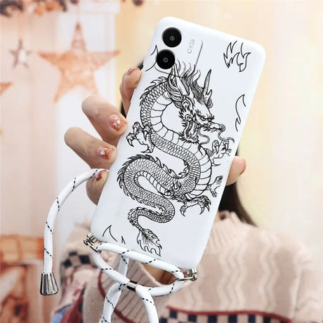 a woman holding a phone case with a dragon on it