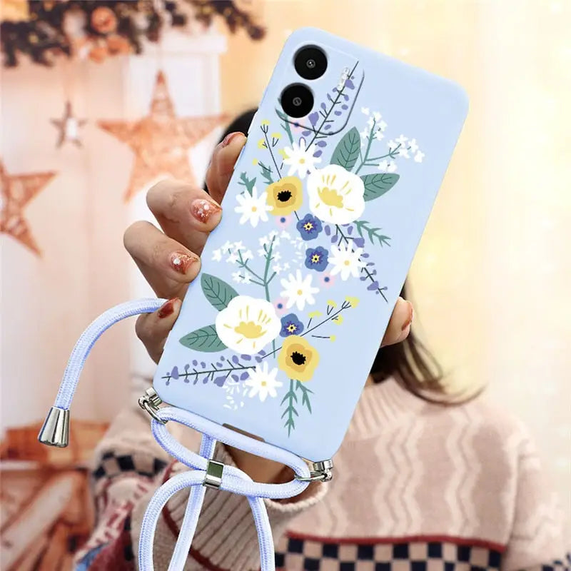 a woman holding a phone case with flowers on it