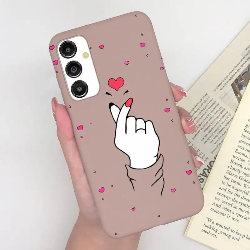 a woman holding a phone case with a heart on it