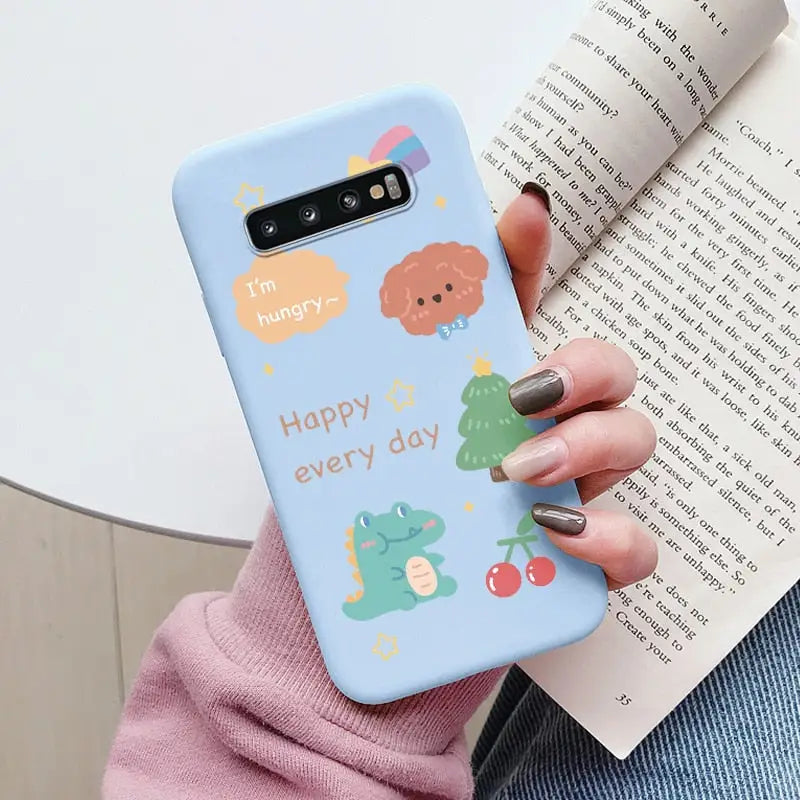 a woman holding a phone case with a cartoon design