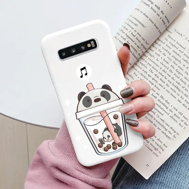 a woman holding a phone case with a cartoon character