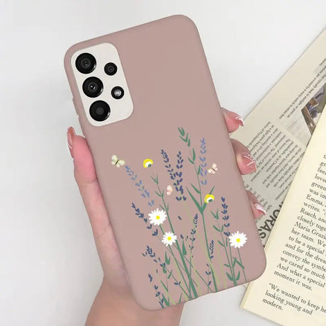 a woman holding a phone case with flowers on it