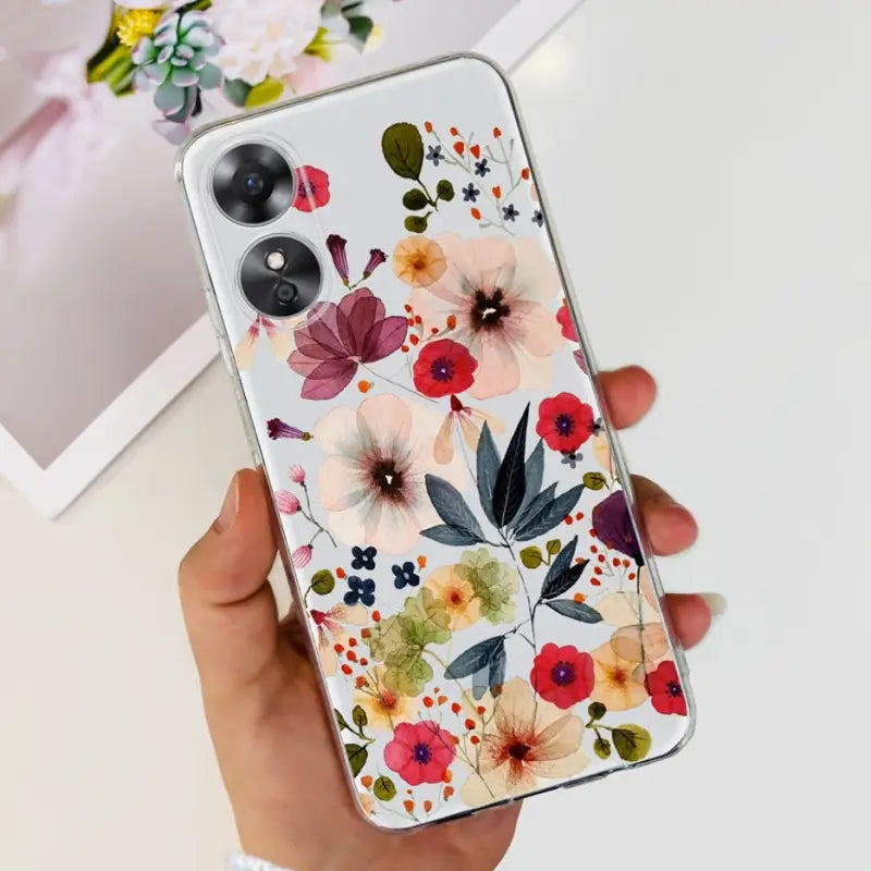 a woman holding a phone case with flowers on it