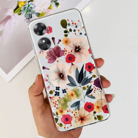a woman holding a phone case with flowers on it