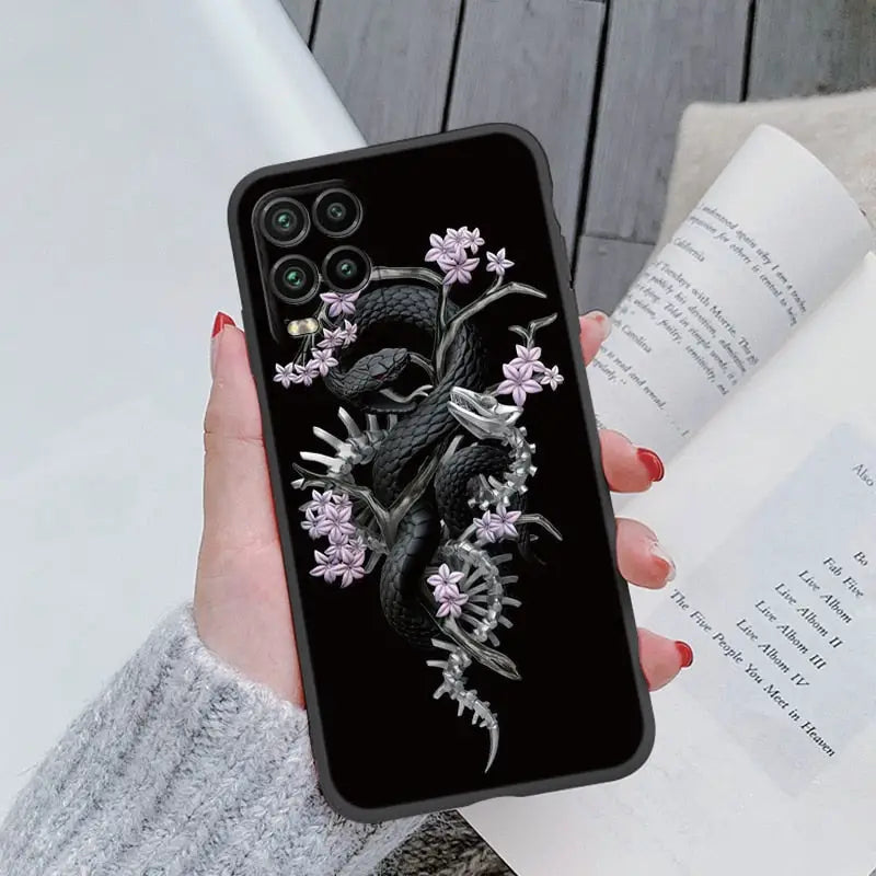 a woman holding a phone case with a dragon on it
