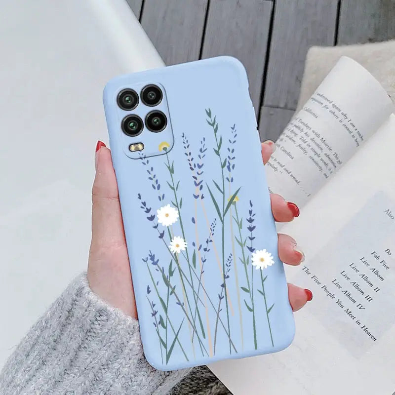 a woman holding a phone case with flowers on it