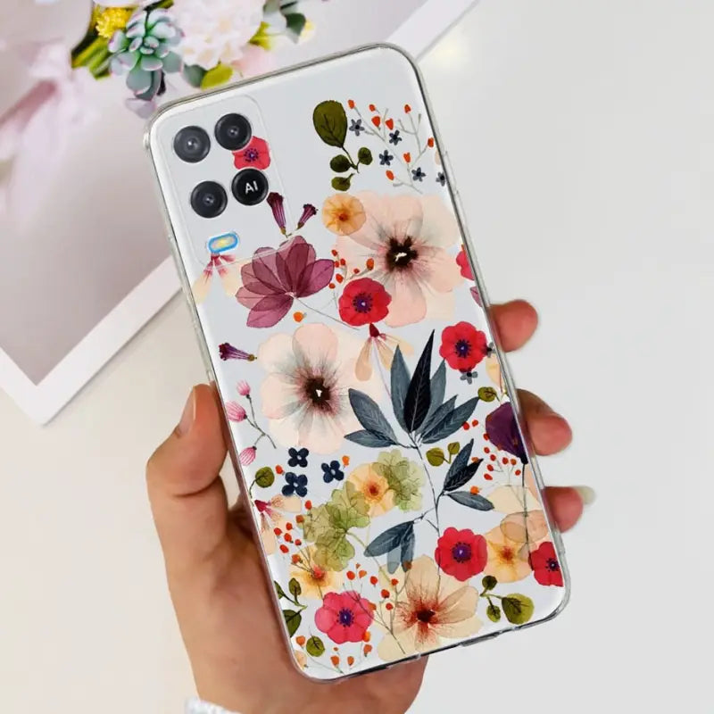 a woman holding a phone case with flowers on it
