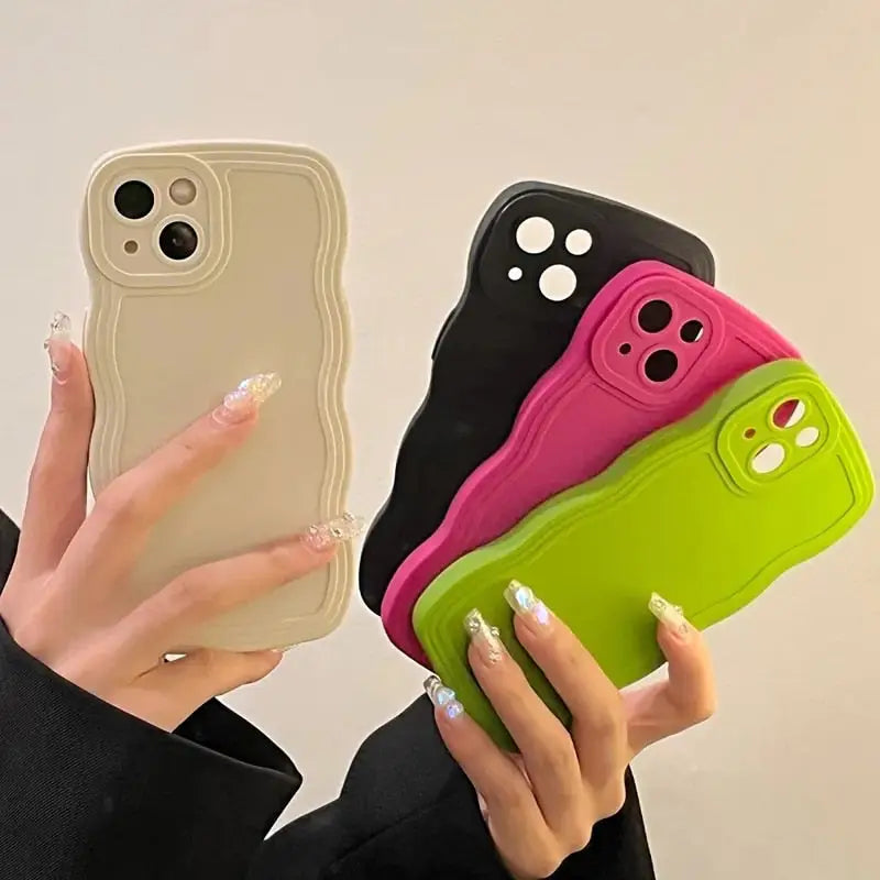 a woman holding a phone case with two different colors