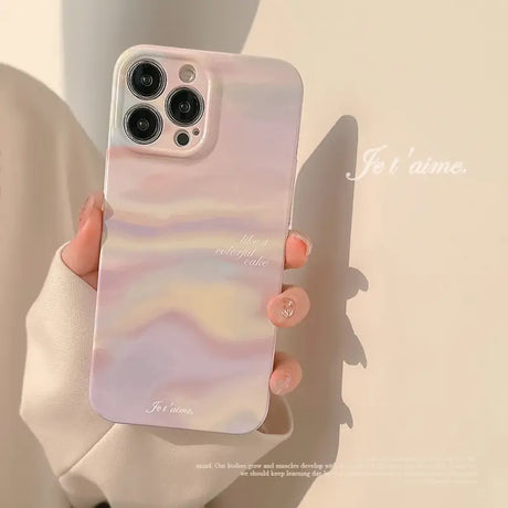 a woman holding a phone case with a pink and white marble pattern
