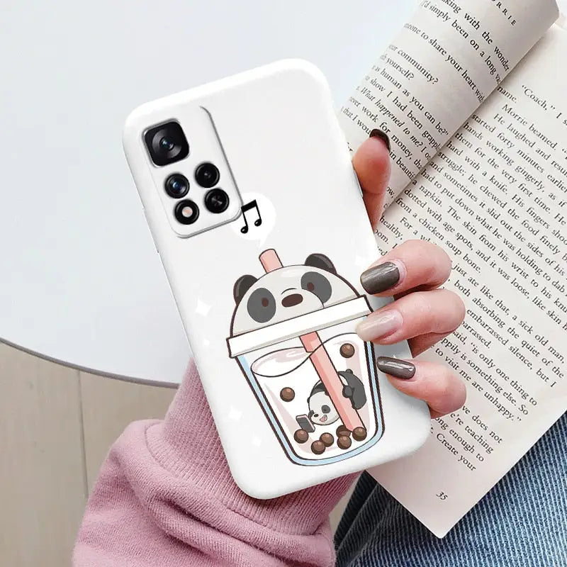 a woman holding a phone case with a cartoon character