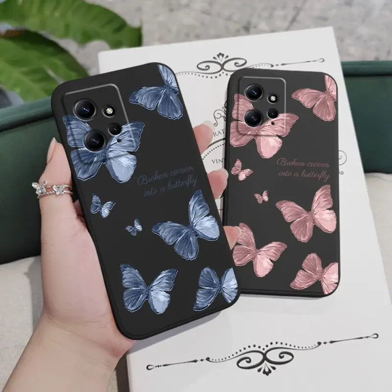 a woman holding a phone case with butterflies on it