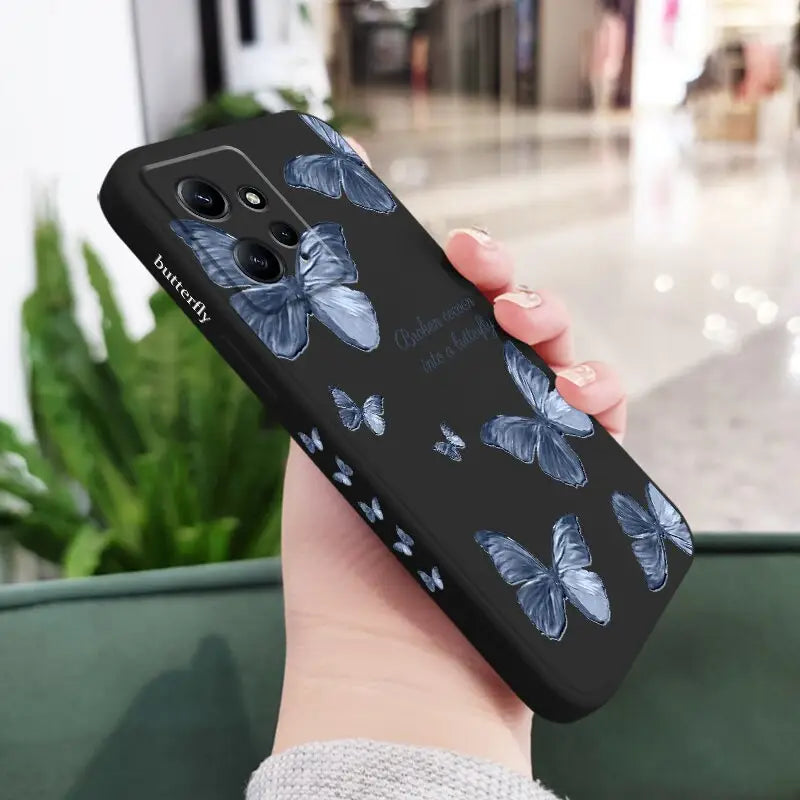 a woman holding a phone case with a blue flower pattern