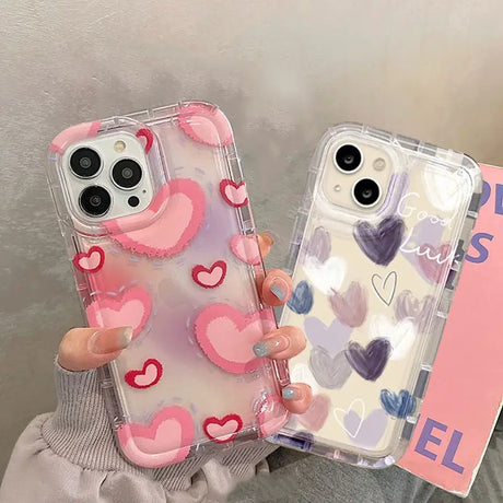 a woman holding a phone case with hearts on it