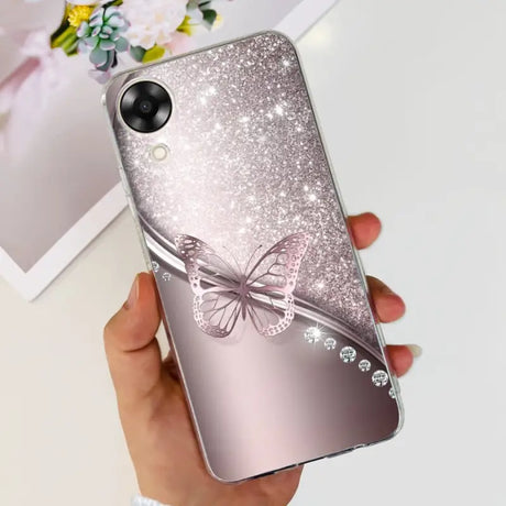 a woman holding a phone case with a butterfly on it