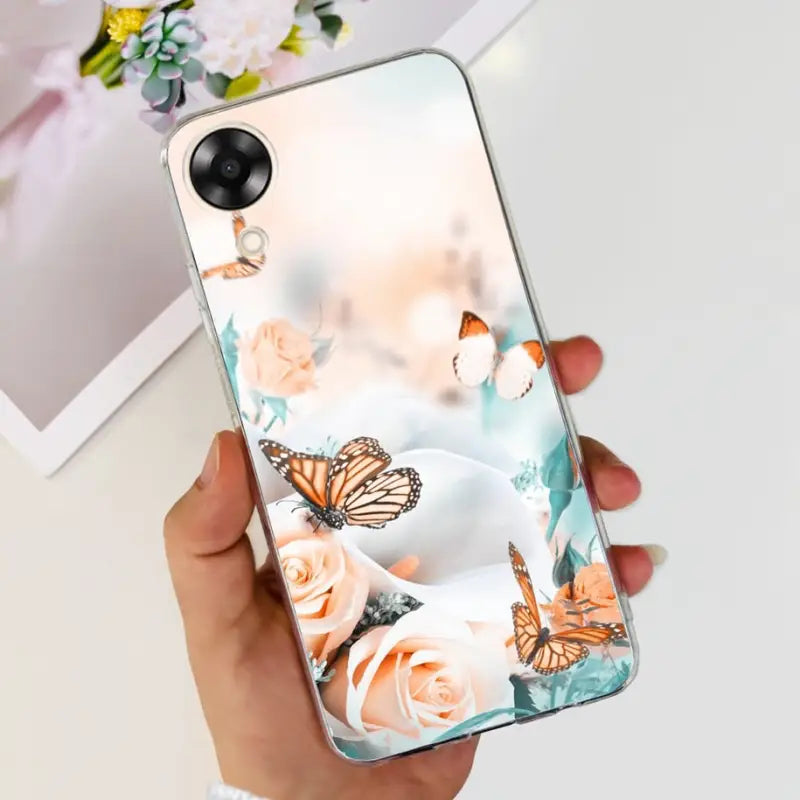 a woman holding a phone case with a butterfly and flowers on it