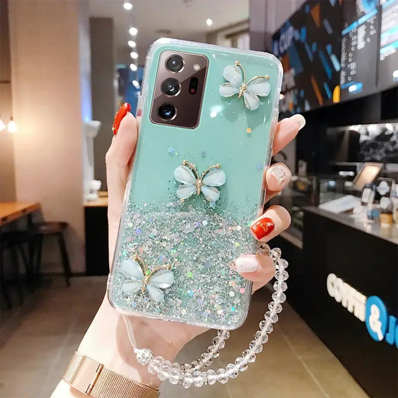 a woman holding a phone case with a butterfly on it