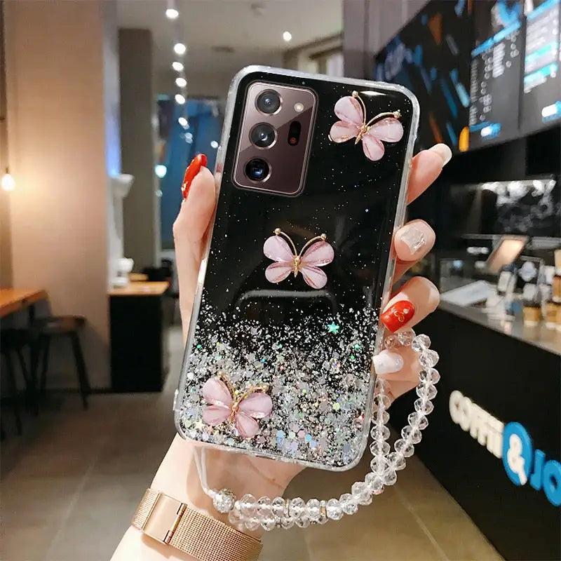 a woman holding a phone case with flowers on it
