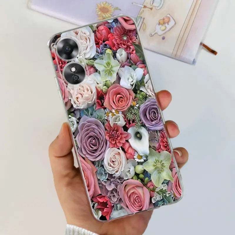 a woman holding a phone case with flowers on it